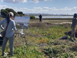 Photo of artists painting the Kendall-Frost Marsh.