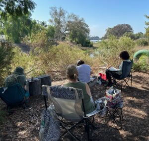 People painting along the Rose Creek Salt Marsh
